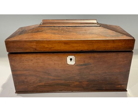 A Victorian rosewood tea caddy of sarcophagus form, the hinged lid opening to reveal a central cut glass mixing bowl flanked 