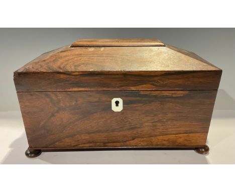A William IV rosewood sarcophagus tea caddy, hinged cover enclosing two lidded compartments and mixing bowl aperture, turned 