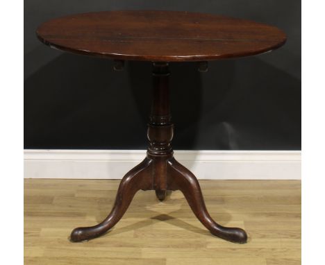 A George III oak tripod occasional table, circular tilting top, turned column, cabriole legs, pad feet, 71.5cm high, 86.5cm d