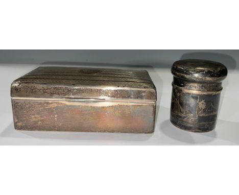 A George V rounded rectangular silver cigarette box, engine turned, vacant central circular cartouche, hinged cover, cedar li