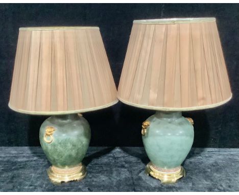 A pair of Chinese reproduction ovoid table lamps, lion mask faux ring handles, moss green ground above a geometric band, bras