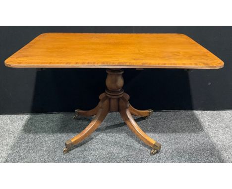 A Regency Revival mahogany rounded rectangular breakfast or centre table, 74cm high, 130.5cm long, 102.5cm wide 