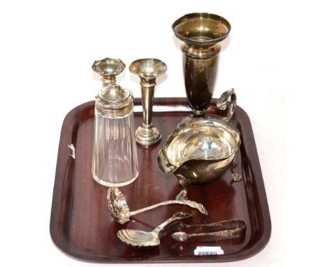 A group of silver comprising George III sauce boat, a caddy spoon, straining spoon, sugar nips, three bud vases and a silver 