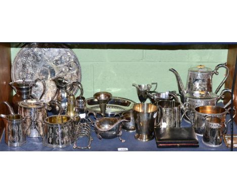 A shelf of Victorian and later plated wares, including tea services, casters, gallery tray, mug, sauce boat etc 