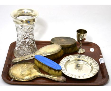 A silver alphabet christening dish, silver and enamel dressing table items, a silver rimmed cut glass vase and a silver chris