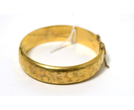 A 9 carat gold hinged bangle 24.07g gross