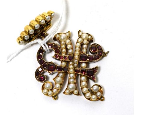 A gem set monogram pendant, an interlocked 'MR' monogram set with calibré cut garnets and seed pearls suspended from a corone