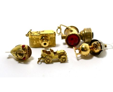 An 18 carat gold chick charm, a Stanhope viewer camera charm, a 9 carat gold car charm, a fish charm and a lantern charm (5) 