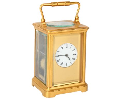 French gilt-brass carriage clock, enamel circular dial in gilded surround, 8-day movement striking on a gong, case height 12c