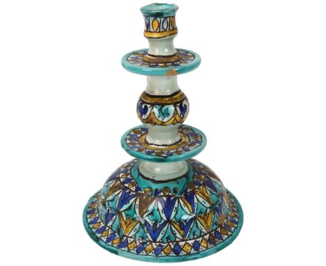 A Moroccan pottery candlestick, with painted decoration, height 24cmChipped top rim, otherwise good condition 