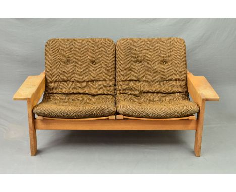 YNGVE EKSTROM FOR SWEDESE, a low oak framed two seater sofa, with shaped armrests and canvas seats with original russet and b