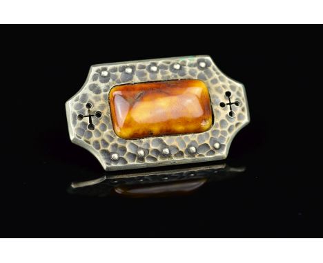 AN ARTS & CRAFTS 'RUSKIN' STYLE BROOCH, the golden rectangular ceramic cabochon to a hammered frame decorated with a bead and