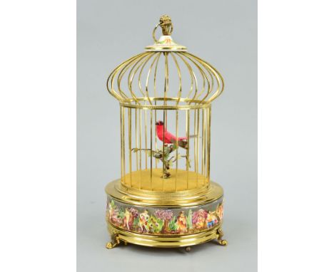 A REUGE MUSIC SAINTE CROIX REPRODUCTION AUTOMATON SINGING BIRD IN A CAGE, the cage with Capo di Monte porcelain mounts to top