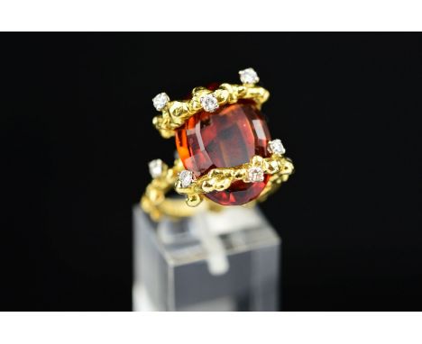 A MID TO LATE 20TH CENTURY ORNATE ABSTRACT CITRINE AND DIAMOND DRESS RING, centring on an oval mixed cut citrine measuring ap