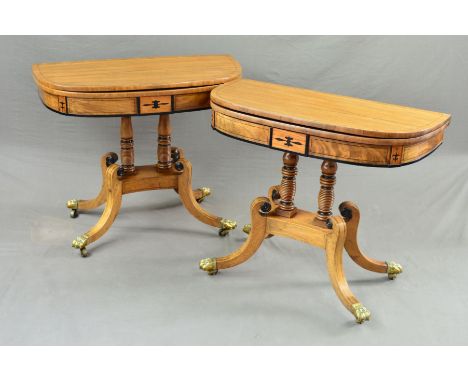 A NEAR PAIR OF REGENCY WALNUT, BRASS AND EBONY INLAID FOLD OVER 'D' SHAPE CARD TABLES, green baize lined interiors, supported