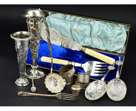 TWO WILLIAM COMYNS SILVER CONICAL POSY VASES, the taller embossed with a stem of lilies, circular loaded foot, London 1908, h