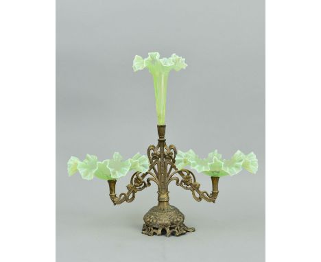 AN ART NOUVEAU GILT METAL AND VASELINE GLASS EPERGNE, central trumpet with wavy rim, above two flower and tendril arms with v