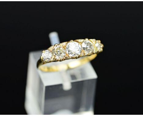 A LATE VICTORIAN DIAMOND CARVED HALF HOOP RING, five old cut diamonds graduating in size from 3.6mm to 5.2mm in diameter, cla