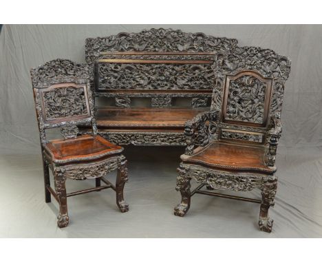 A LATE 19TH CENTURY STYLE ANGLO CHINESE CARVED HARDWOOD SEVEN PIECE SUITE, comprising four salon chairs, a pair of elbow chai