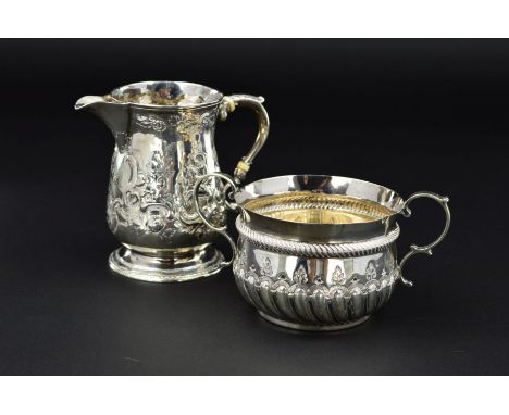 A LATE VICTORIAN SILVER PORRINGER, in an early 18th Century style, 'S' scroll handles, repousse decoration, bears crossed key