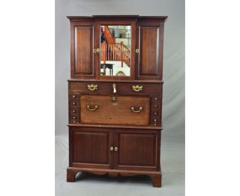 A GEORGE III MAHOGANY SECRETAIRE CABINET, the upper breakfront section with central mirrored cupboard flanked by single door 