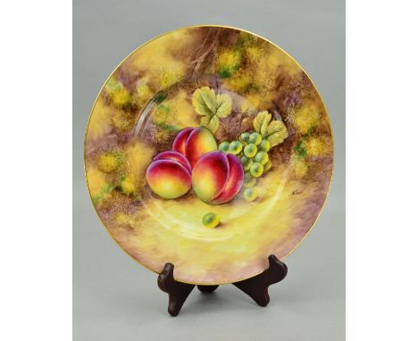 A ROYAL WORCESTER PLATE HAND PAINTED WITH PEACHES AND GRAPES ON A MOSSY BANK, bears signature for John Smith lower right, pri