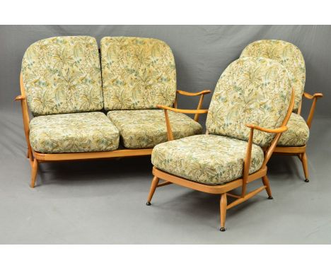 AN ERCOL BLONDE ELM THREE PIECE LOUNGE SUITE, with stick back and shaped armrests, comprising of a three seater settee and a 