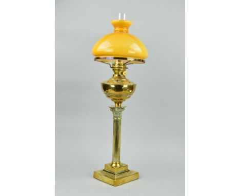 A LATE VICTORIAN BRASS CORINTHIAN COLUMN OIL LAMP, with chimney, opaque mustard coloured glass shade, stepped square base, he