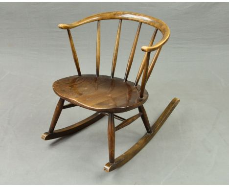 A DARK ERCOL COW HORN STICK BACK ROCKING CHAIR, (condition: few light scratches, varnish faded to arms)