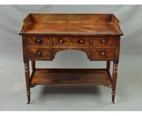 A VICTORIAN MAHOGANY WASHSTAND, the rectangular top with raised back and sides above an arrangement of five drawers with wood