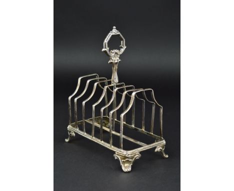 A VICTORIAN SILVER SEVEN BAR TOAST RACK, of rectangular form, foliate cast handle, scroll feet, one with registration mark on