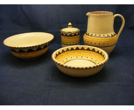 Two Poole pottery bowls, a jug and a mustard pot
