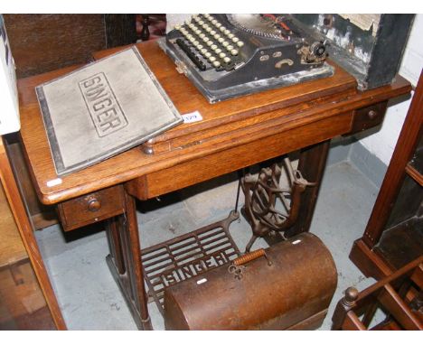 A Singer sewing machine together with a portable typewriter