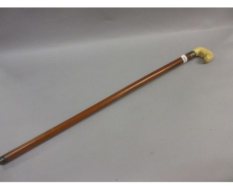 Late 19th or early 20th Century Malacca walking stick with ivory handle together with an African carved hardwood walking stic