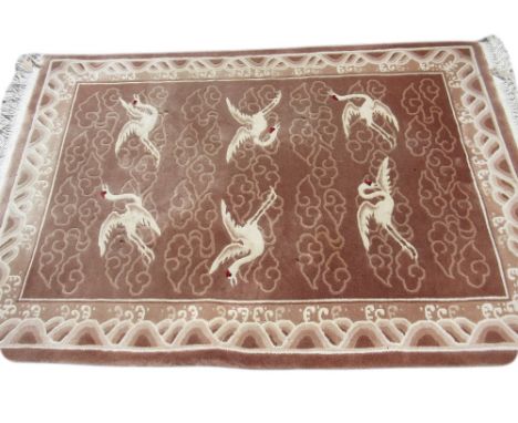 Large Chinese carpet with embossed design in shades of mid and light brown, 9ft x 12ft approximately, together with a matchin