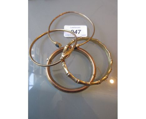9ct Gold bangle in the form of a serpent together with another 9ct gold bangle and two silver gilt bangles