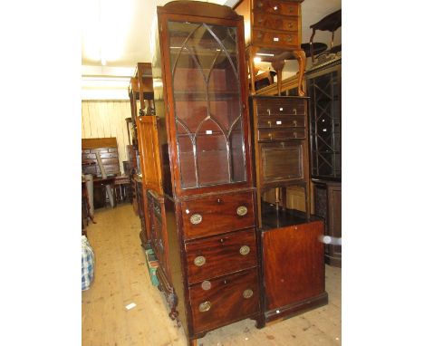 Narrow mahogany bookcase with a bar glazed door above three drawers with oval brass handles and bracket feet (alteration)