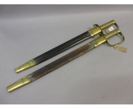 19th Century possibly French bayonet / side arm, the ribbed brass grip with shaped hilt and hand guard above a steel saw toot