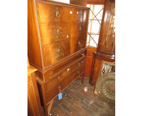 Early 20th Century mahogany chest with gadroon moulding surrounding three graduated drawers with brass ring handles and pierc