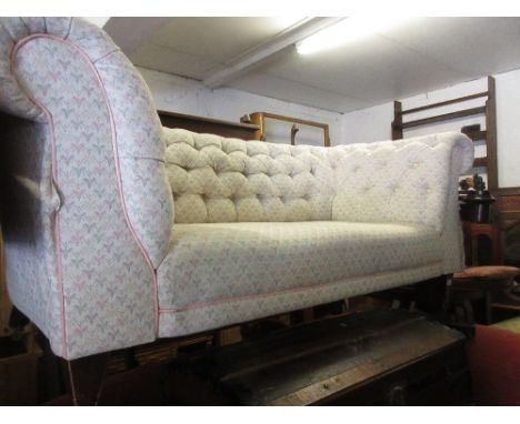 Early 20th Century button upholstered Chesterfield type sofa on square tapering supports with casters