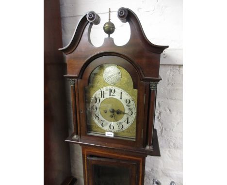 Edwardian mahogany longcase clock, the engraved brass arch top dial having silvered chapter ring with Arabic numerals and thr