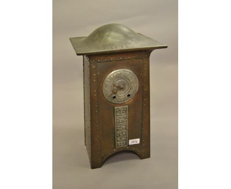 Arts and Crafts copper and white metal mounted mantel clock of architectural form, the dome top above a silvered dial with Ar