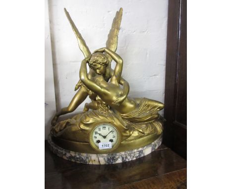 19th Century gold patinated spelter clock in the form of Cupid and Psyche, mounted on a marble plinth base, the two train mov