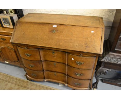 18th Century Continental oak bureau, the fall front enclosing a fitted interior above three serpentine fronted drawers, raise
