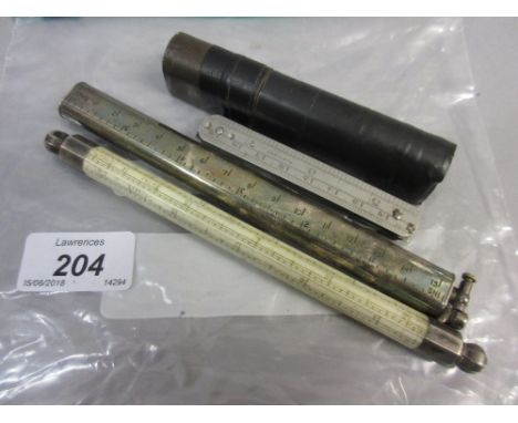 Unusual Dunhill cigarette lighter formed as a rule, together with an Italian octagonal rule, a penknife rule and a Rabone bra
