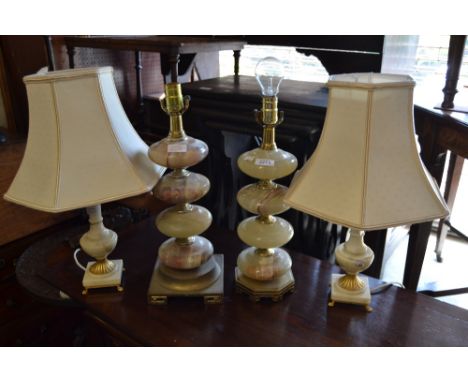 Pair of turned onyx table lamps together with a pair of alabaster and gilt metal table lamps and a gilt brass and stone table