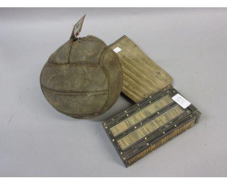 Early leather football, pair of shin pads and a porcupine quill box