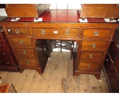 Edwardian beechwood twin pedestal desk with a red leather inset top above nine drawers with brass ring handles, raised on spl