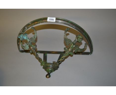 Small 20th Century verdigris decorated brass wall bracket, the supports in the form of dragons heads with glass top, 18ins wi