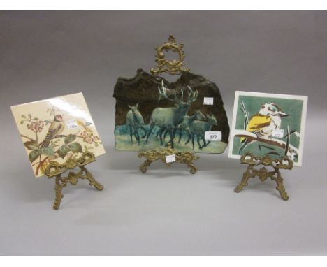 North American enamel decorated slate plaque depicting deer, a Minton tile decorated with a bird together with another tile, 